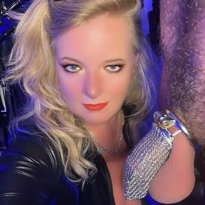 scarlett black chastity mistress next to a man in chastity