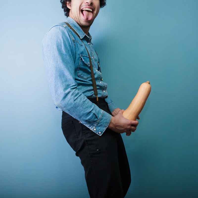 humorous picture of a man holding a vegetable with a cheeky expression