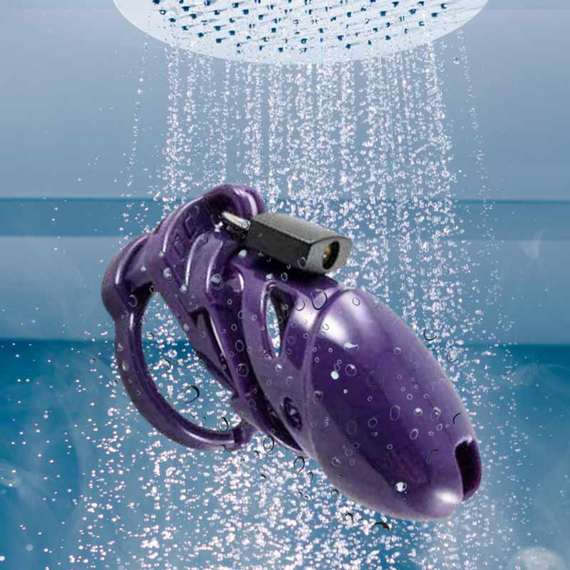 a chastity cage being washed with water